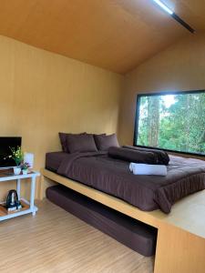 a large bed in a room with a window at Great Panorama Lodge and Camping in Lembang