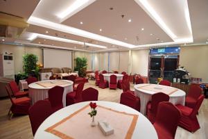 a conference room with tables and red chairs at Emirates Stars Hotel Apartments Dubai in Dubai