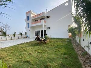 two people sitting in chairs in front of a building at Hotel saanjh haveli in Orchha