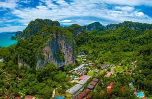 an aerial view of a village in front of a mountain at Diamond Cave Resort in Railay Beach