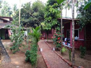 a house with a garden next to a house at Sai Sadan Residency,Diveagar in Diveagar