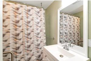 a bathroom with a shower curtain and a sink at Victorian Villa: Interns or family in Seattle