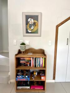 a book shelf filled with books in a room at Devine Stay in Paarl