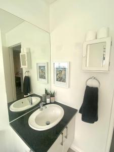 a bathroom with a sink and a mirror at Devine Stay in Paarl
