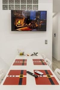 a dining room table with a fireplace in the background at The Golden home 1 in Piraeus
