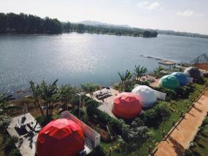 an aerial view of a lake with several domes at Kravanh Camping Cardamom Mountain in Véal Vêng