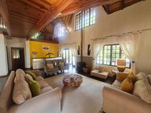 a large living room with couches and a table at 60 on Monica, 6 Bedroom Lesedi Lodge, Hartbeespoort in Hartbeespoort