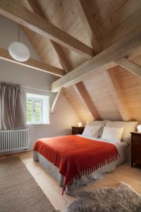 a bedroom with a red bed in a attic at Chaloupka Dvě Sestry in Kořenov