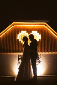 une mariée et un marié debout devant un bâtiment dans l'établissement Resort Village Majer, à Gradac