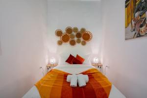 a bedroom with a colorful bed with two towels at RIAD AMR in Tangier