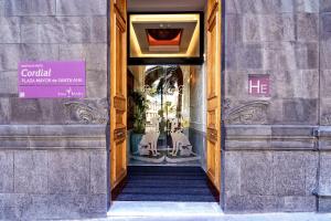 a hallway to a store with a sign on the door at Boutique Hotel Cordial Plaza Mayor de Santa Ana in Las Palmas de Gran Canaria