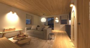 ein Wohnzimmer mit einem Sofa und einem Tisch in der Unterkunft DALANIA MOUNTAIN APARTMENTS in Ponte di Legno