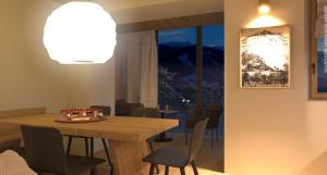 a dining room with a wooden table and chairs at DALANIA MOUNTAIN APARTMENTS in Ponte di Legno