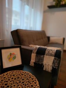 a living room with a couch and a table with a blanket at Apartament Baldachówka in Rzeszów
