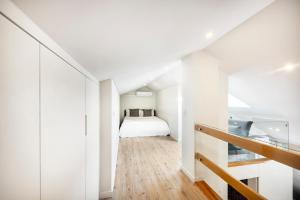 a bedroom with a bed in a white room at Lisbon Oriente Suites by Olala Homes in Lisbon