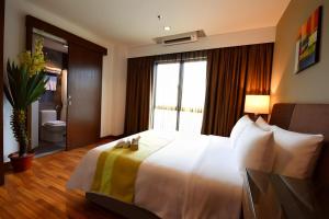a hotel room with a large bed and a window at Imperial Heritage Hotel Melaka I City Centre I Free Wifi I Free Parking l Free Club Lounge Access in Melaka