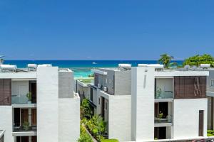 an apartment building with the ocean in the background at Residence Potosi in Trou aux Biches