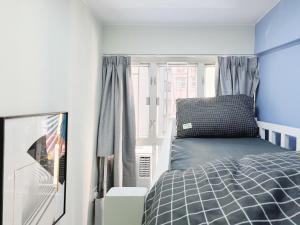 Rúm í herbergi á Student Accommodation - 188 Wan Chai Road