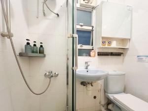 a bathroom with a shower and a toilet and a sink at Student Accommodation - 188 Wan Chai Road in Hong Kong