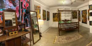 a room with a crib in a room with paintings at Segar Art Gallery in Ja-Ela