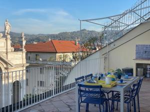 a table and chairs on the balcony of a building at La Terrazza sui Tetti nel cuore di Torino in Turin