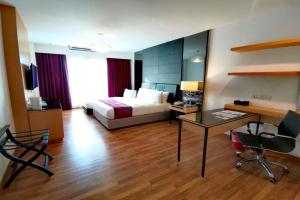 a hotel room with a bed and a desk at Imperial Heritage Hotel Melaka I City Centre I Free Wifi I Free Parking l Free Club Lounge Access in Melaka