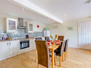 a kitchen and dining room with a table and chairs at 3 Bed in Bruton HTORV in Castle Cary