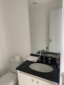 a bathroom with a sink and a toilet at Studio metrô Belém 2 in Sao Paulo