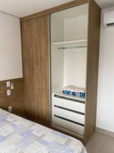 a bedroom with a closet with a bed in it at Studio metrô Belém 2 in Sao Paulo
