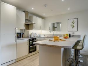 a kitchen with white cabinets and a counter top at 2 Bed in Usk 87950 in Trostrey