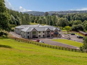 an aerial view of a large house with a grass field at 2 Bed in Usk 87950 in Trostrey
