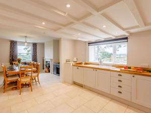 a kitchen with a table and a dining room at 4 Bed in Welshpool 89012 in Llanfair Caereinion