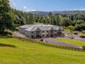 an aerial view of a house with a grass field at 2 Bed in Usk 87949 in Trostrey