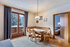 a dining room with a table and chairs at Schwüwong - Apartment 02 in Kelchsau