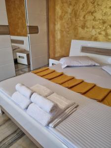 a bed with folded towels on it in a room at Panorama view with terrace in Bucharest