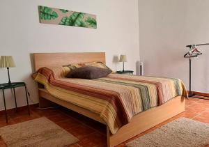 1 cama en un dormitorio con 2 mesas y 2 lámparas en ALGARVE TYPICAL DOWNTOWN HOUSE, en Faro