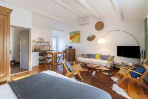 a living room with a couch and a table at Mas la Pauline Gîtes de charme & roulotte in Saint-Rémy-de-Provence