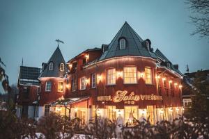 a large building with lights in front of it at Galia in Druskininkai