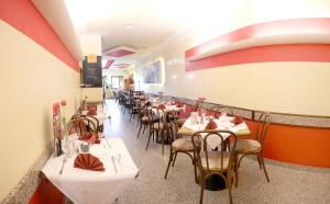 a row of tables and chairs in a restaurant at Eiscafe-Pizzeria-Hotel Rialto in Eilenburg