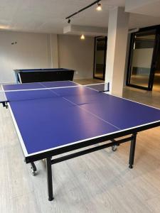 a purple ping pong table in an empty room at Circa Apartment 86 in Pretoria