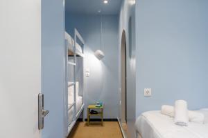 une chambre aux murs bleus et deux lits dans l'établissement Cabins Sleeping, à Athènes