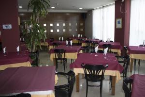 Hotel Costa Blanca في Granja de Rocamora: غرفة طعام مع طاولات وكراسي أرجوانية