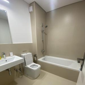 a bathroom with a toilet and a sink and a bath tub at Sidrah House in Riyadh