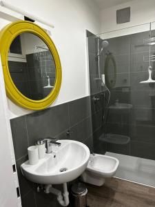 un bagno con lavandino, specchio e doccia di Townhouse Bozen a Bolzano Altre 8 foto