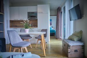 a kitchen with a table and chairs in a room at Gronenberger Mühle Haus 6 in Scharbeutz