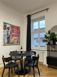 a dining room with a table and chairs and a window at Rochus Stylish Stays in Vienna