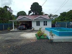 une petite maison avec une baignoire bleue en face de celle-ci dans l'établissement Hana homestay D Yan Bedroom3, à Yan