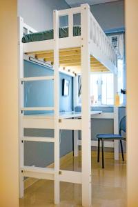 a white bunk bed with a desk in a room at Student Accommodation - 290 Hennessy Road in Hong Kong