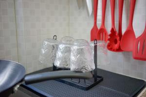 a group of glass containers on a counter with utensils at Student Accommodation - 290 Hennessy Road in Hong Kong