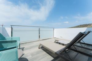 a balcony with a table and chairs on a ship at Hotel Orosol in San Antonio